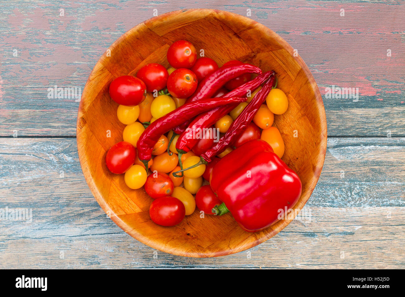 Bowl full of tomatoes, sweet paprika and chili pepper Stock Photo