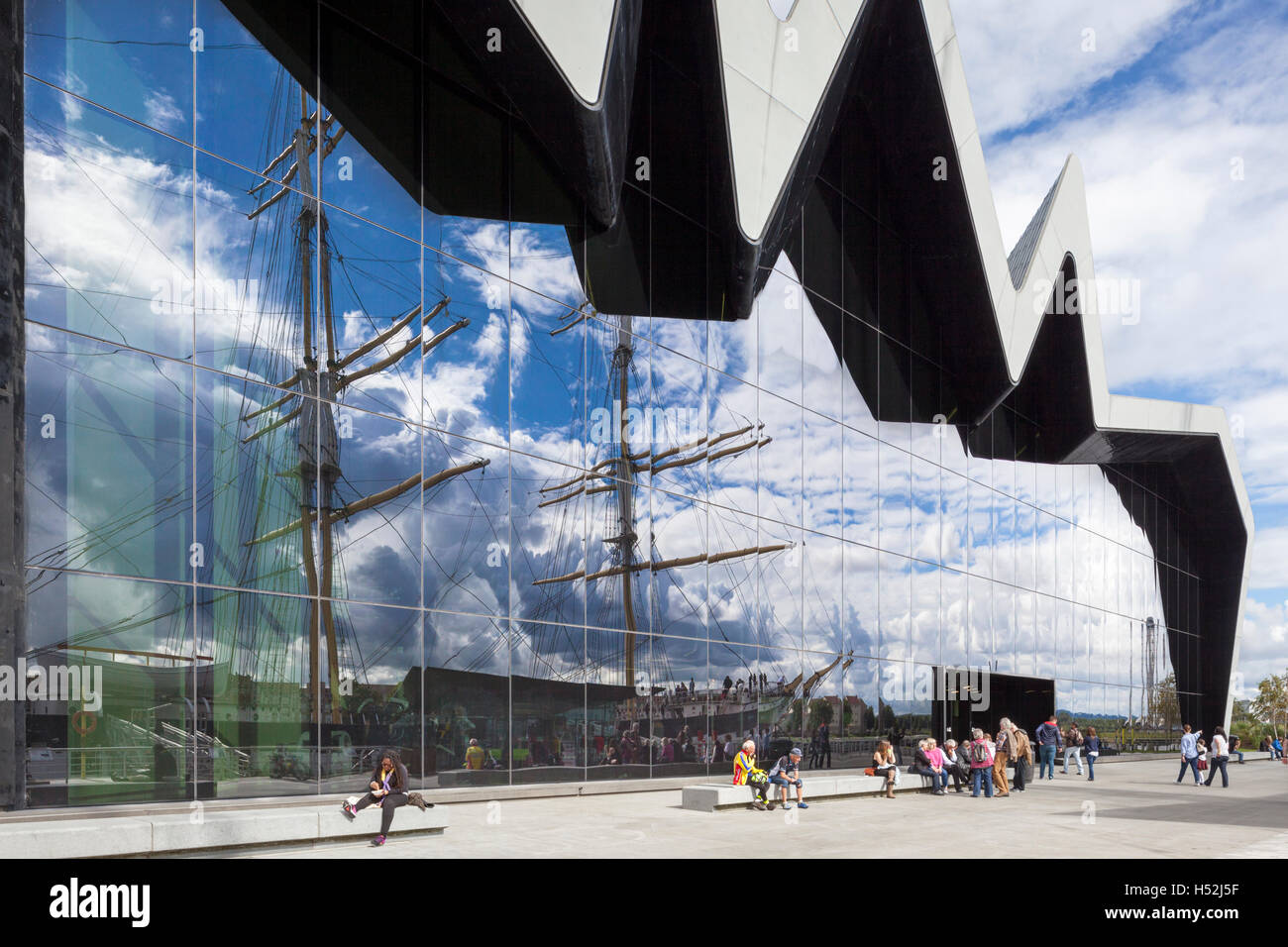 The Riverside Museum of Transport and Travel beside the River Clyde, Glasgow, Scotland UK - The reflection is tall ship Glenlee. Stock Photo