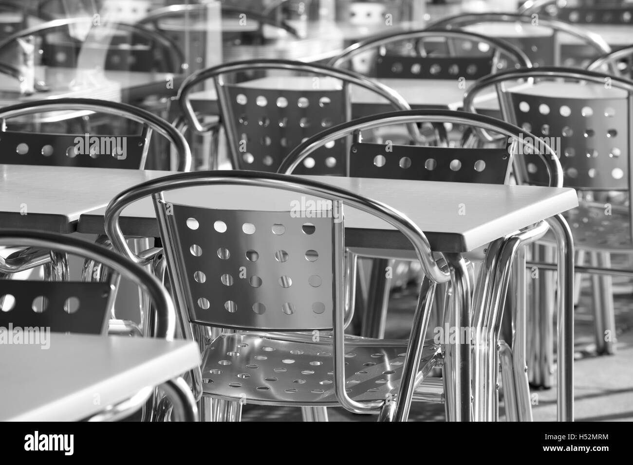 Restaurant metallic chairs group outdoors in black and white. Horizontal Stock Photo