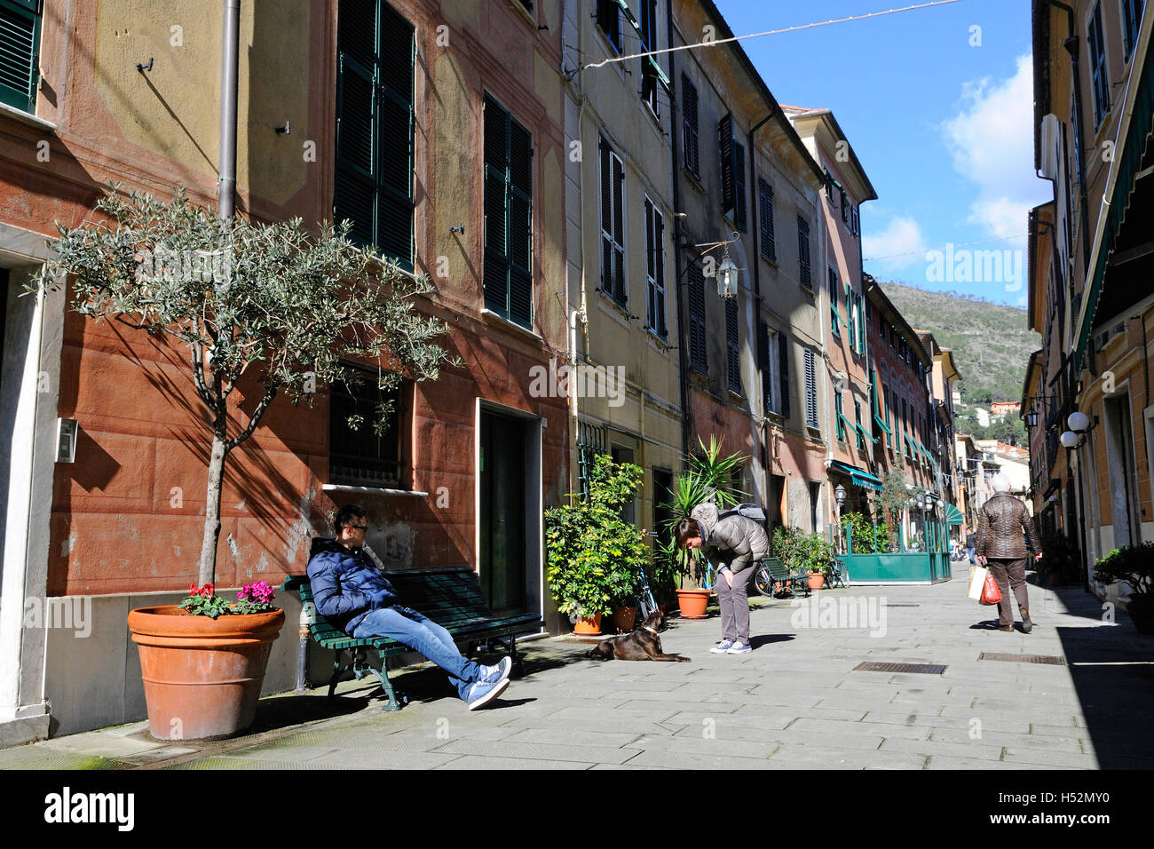 Streetview in Levanto (Liguria) Italy, with people sitting on bench. Stock Photo