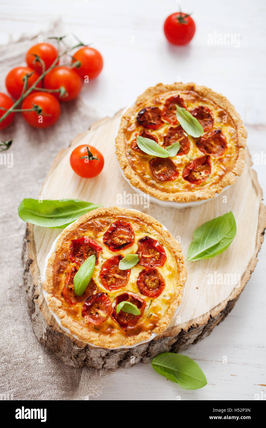 Homemade tomato tartlets with basil leaves Stock Photo