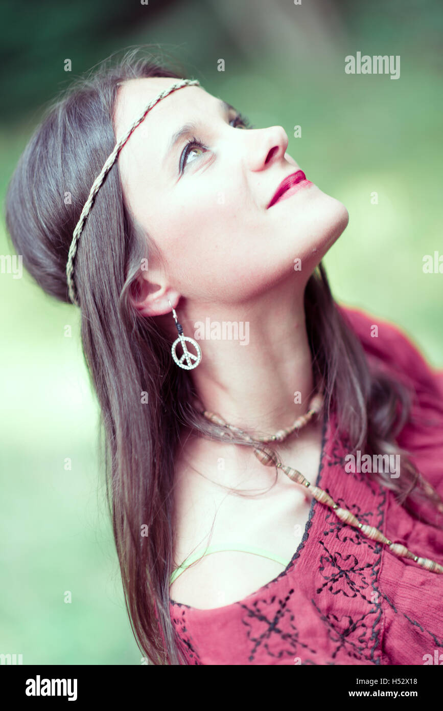 Girl with earring hippie peace symbol, make love not war. Stock Photo