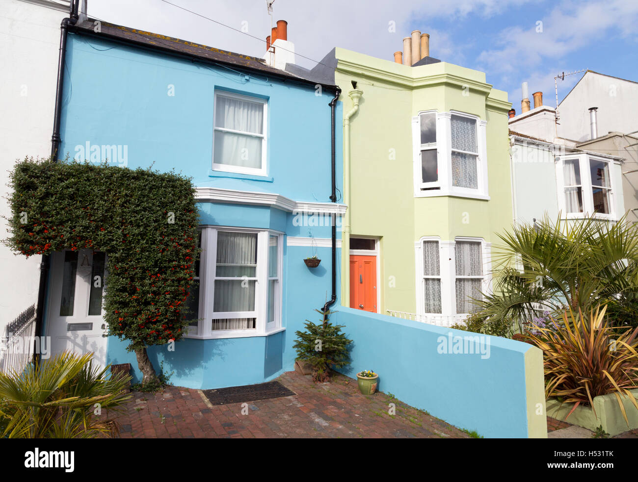A pair of brightly coloured terraced houses in the Lanes, Brighton Sussex UK Stock Photo