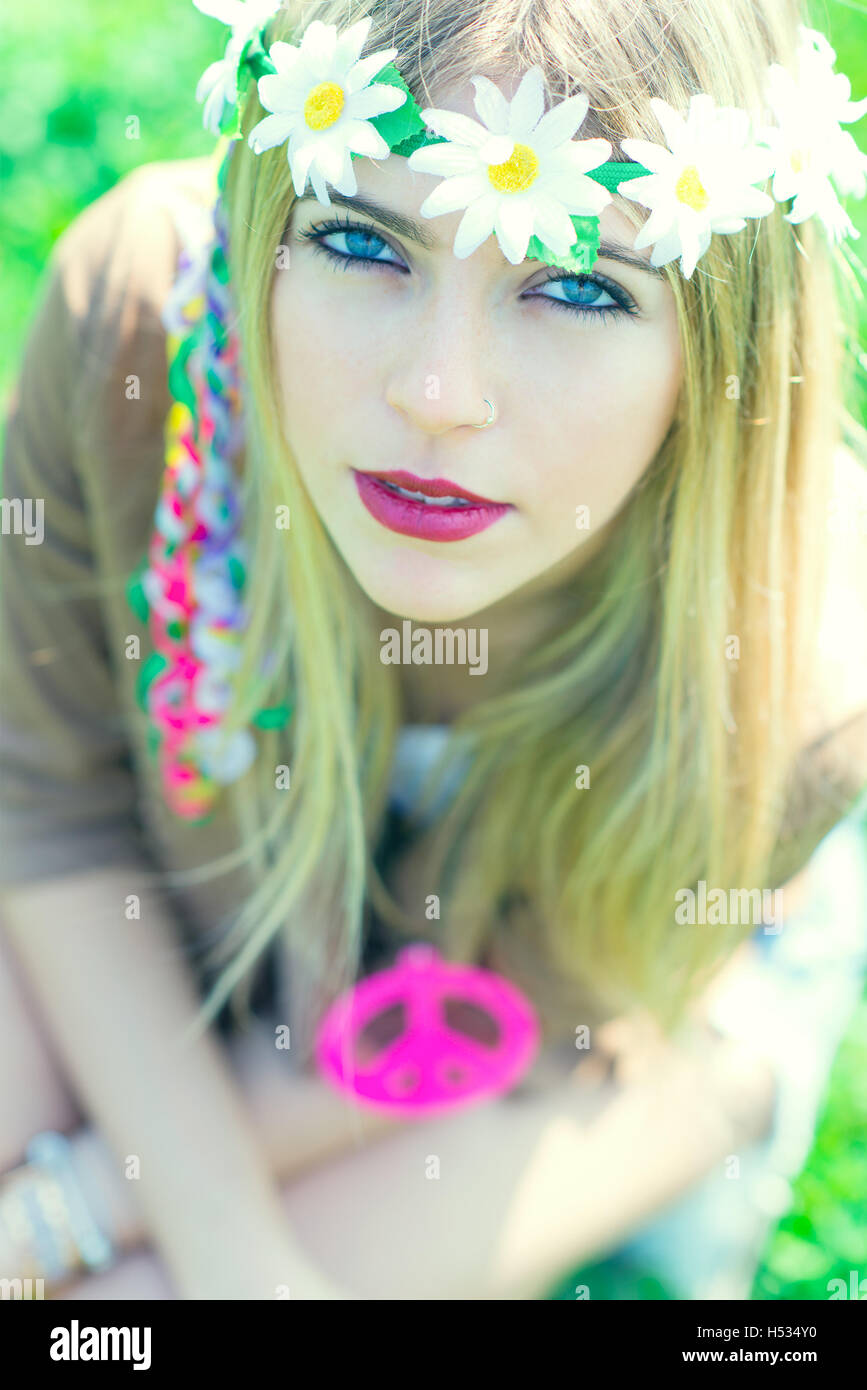 hippie girl with flower headband and necklace with peace sign Stock Photo