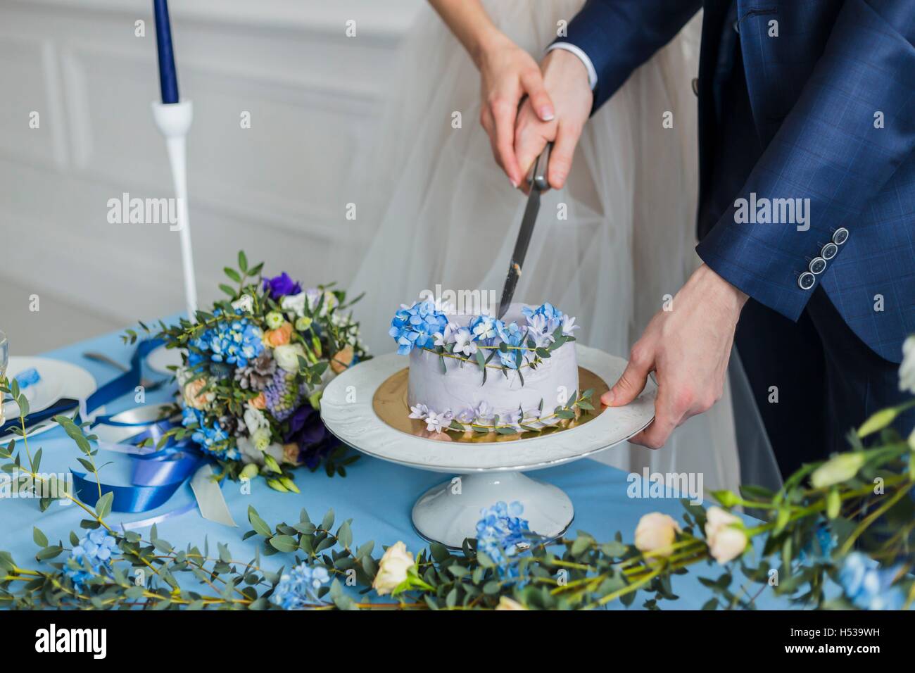 Bride and groom at wedding cutting the  cake Stock Photo