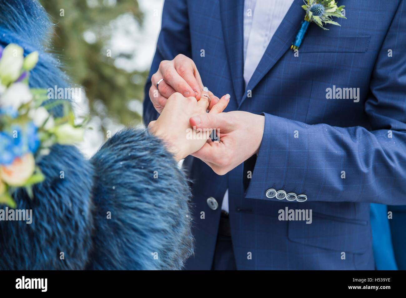 Close up groom put the wedding ring on bride Stock Photo Alamy
