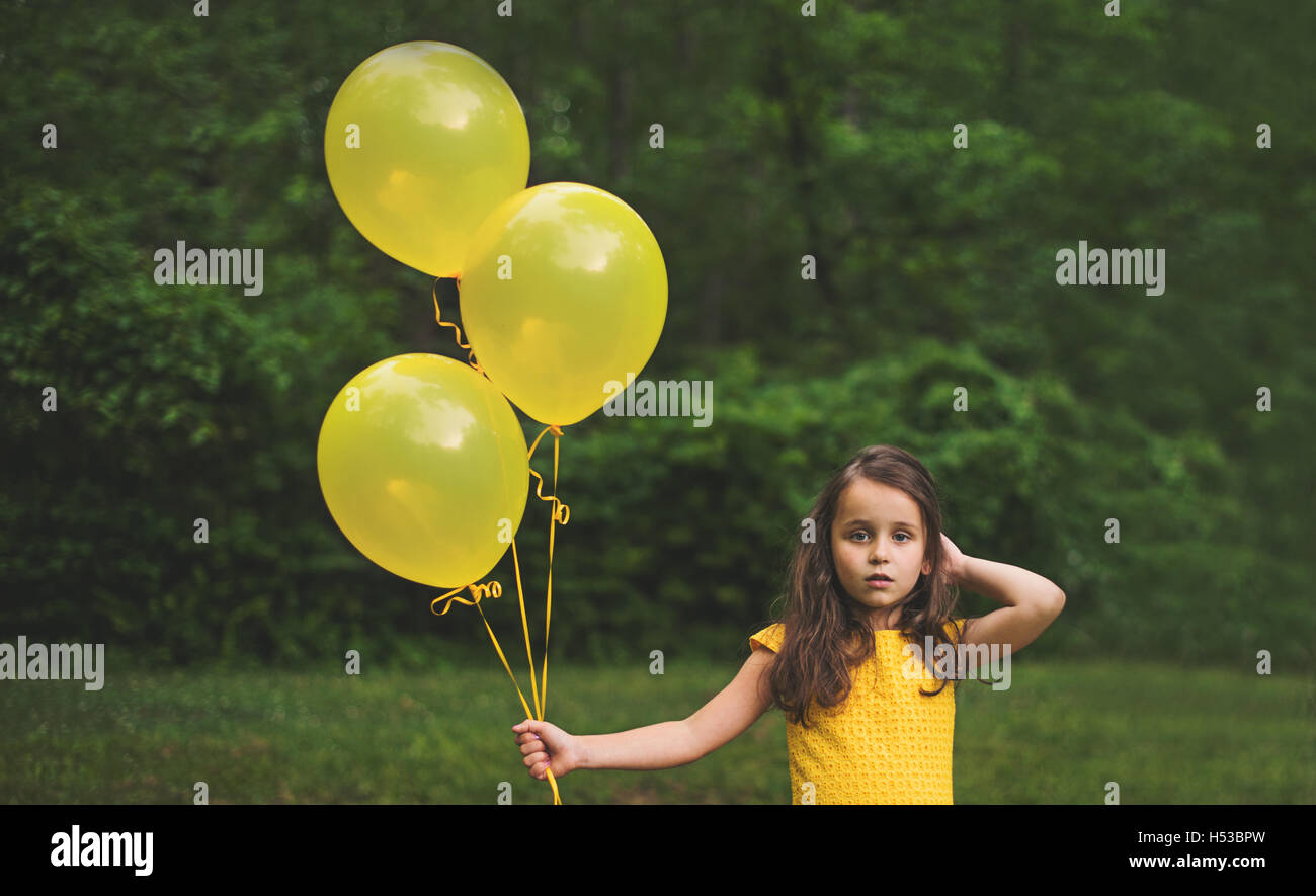 Young girl holding balloons hires stock photography and images Alamy