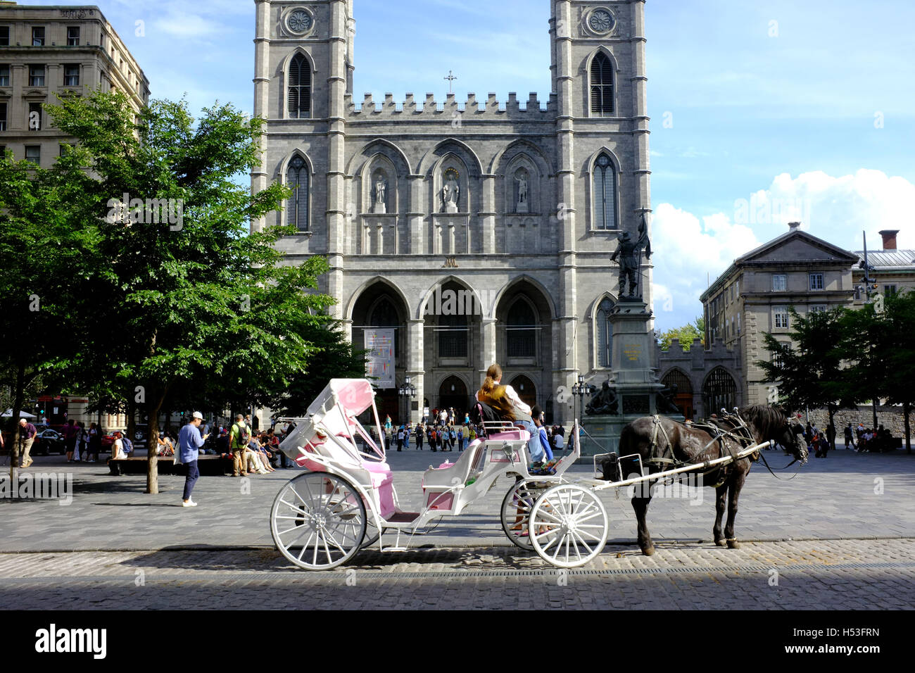 A horse and carriage parked in the Place d' Armes in Montreal Stock Photo