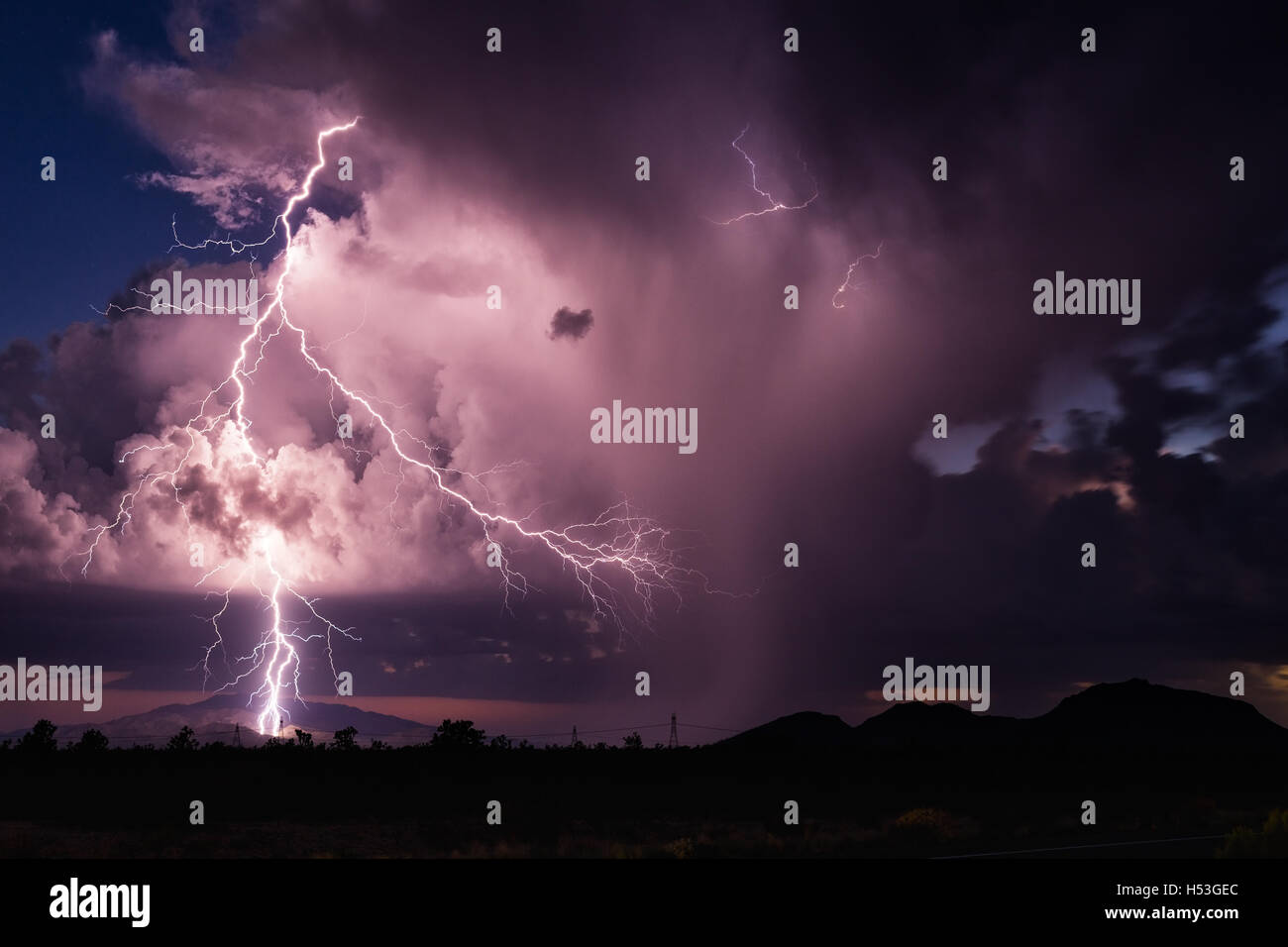 Lightning bolt striking a mountain in a storm near Wickenburg, Arizona Stock Photo