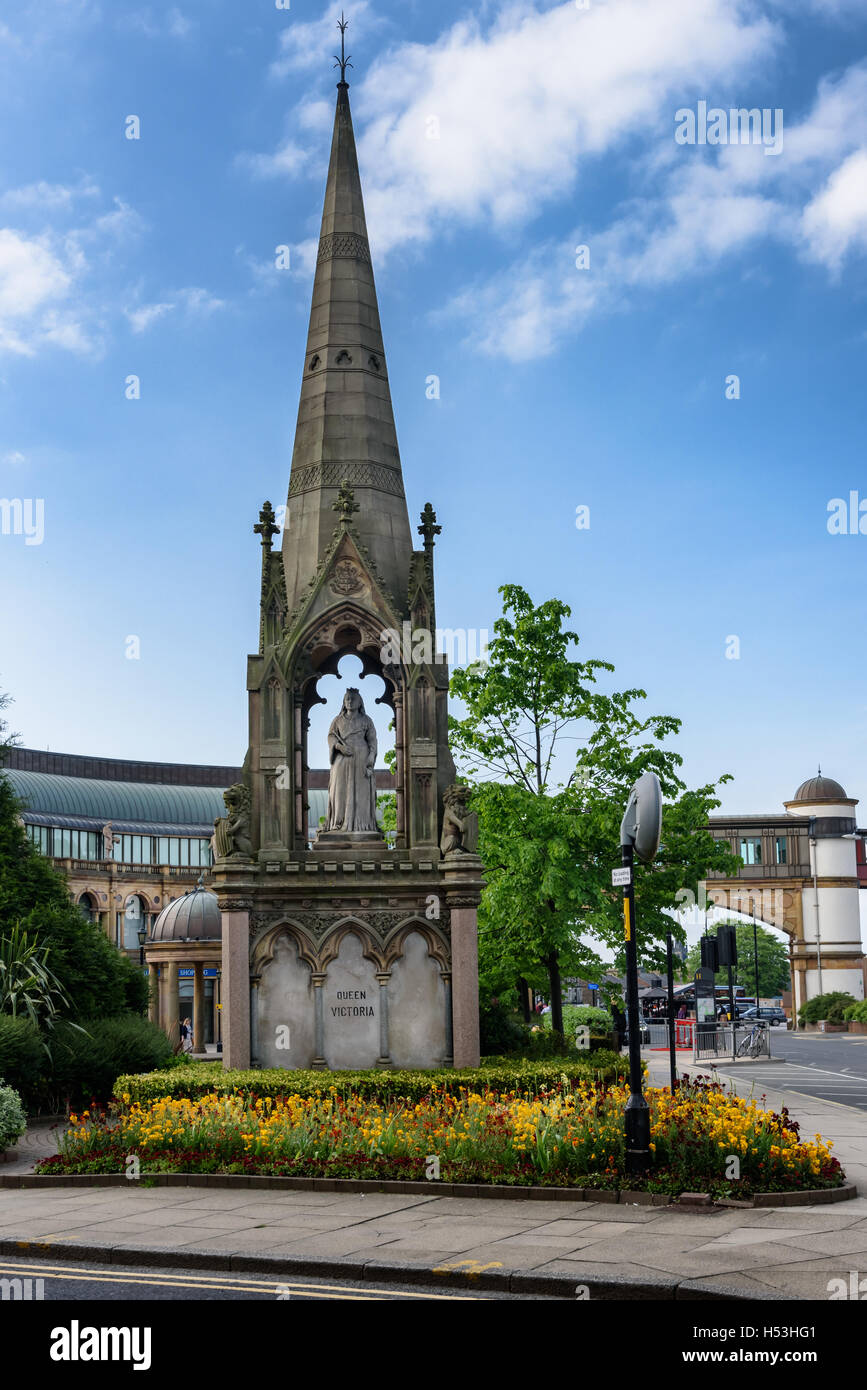The statue stands on a high plinth and rising above the statute is a tall spire that provides cover for it, Harrogate, England. Stock Photo