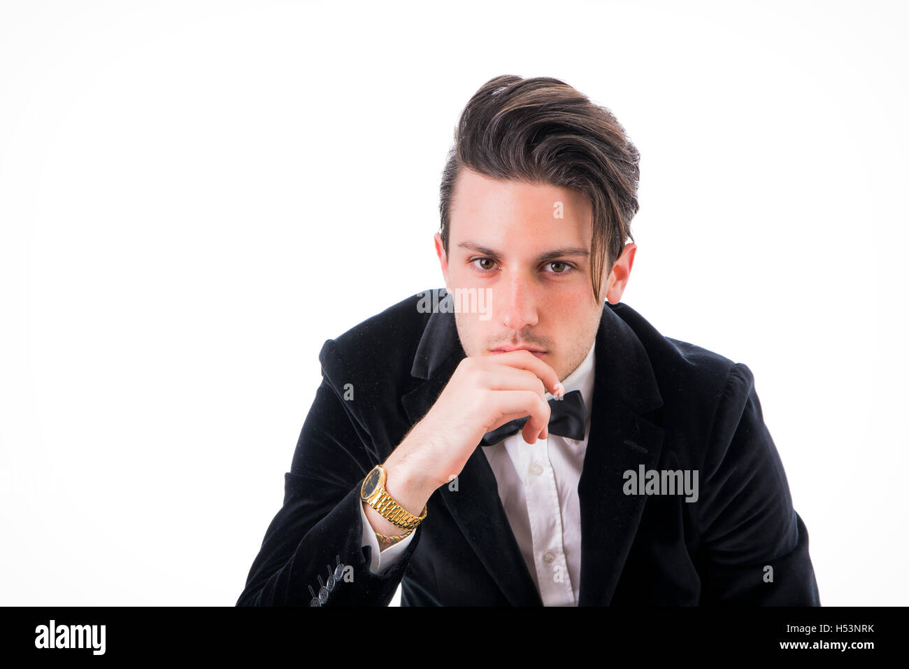 Young businessman confidently posing and looking to a side, wearing ...