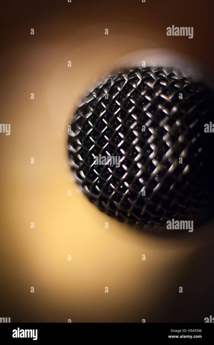 Microphone head extreme close up out of focus stage lights in background vertical image Stock Photo