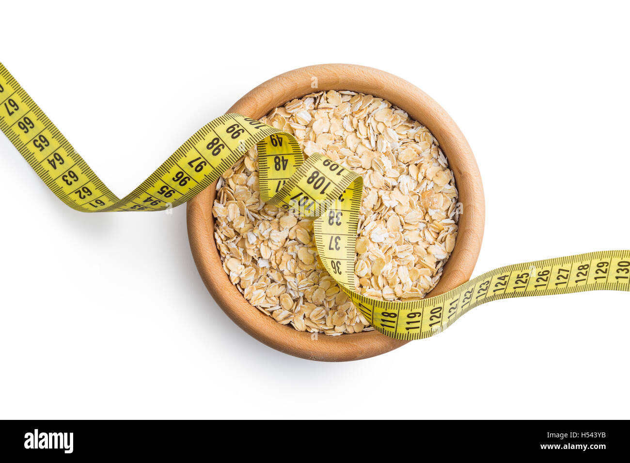 Diet concept. Dry rolled oatmeal and measuring tape. Stock Photo