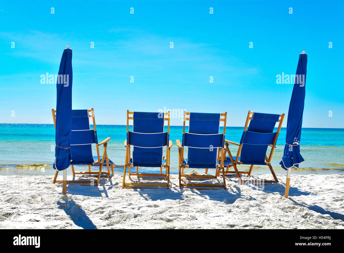 Chaise longues on beach with umbrellas in Destin Sandestin Florida Stock Photo