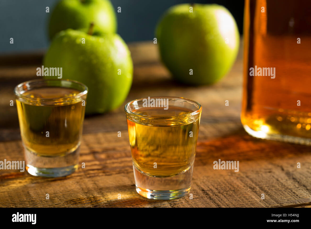 Alcoholic Apple Flavored Bourbon Whiskey in a Shot Glass Stock Photo