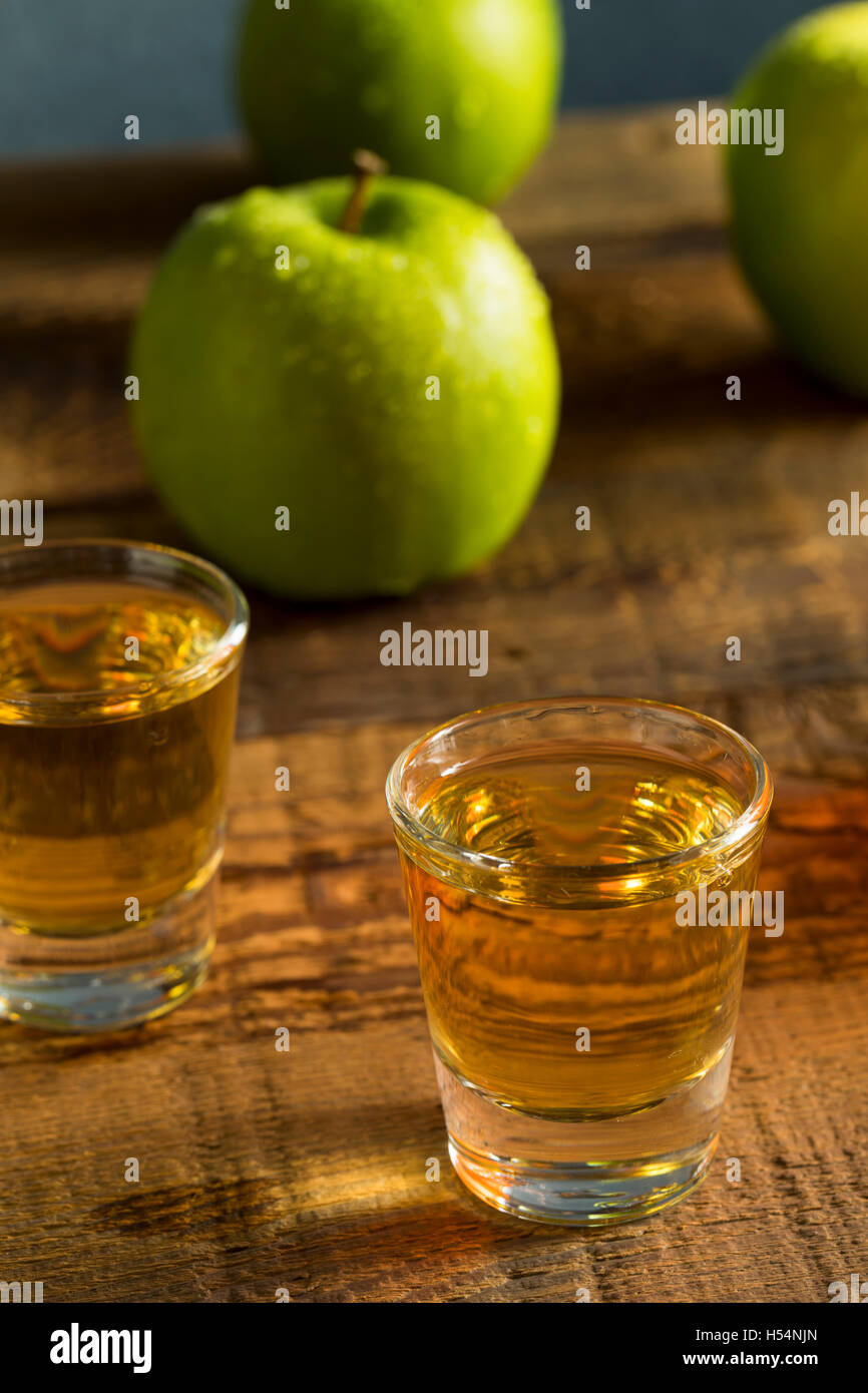 Alcoholic Apple Flavored Bourbon Whiskey in a Shot Glass Stock Photo