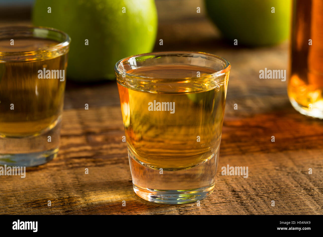 Alcoholic Apple Flavored Bourbon Whiskey in a Shot Glass Stock Photo