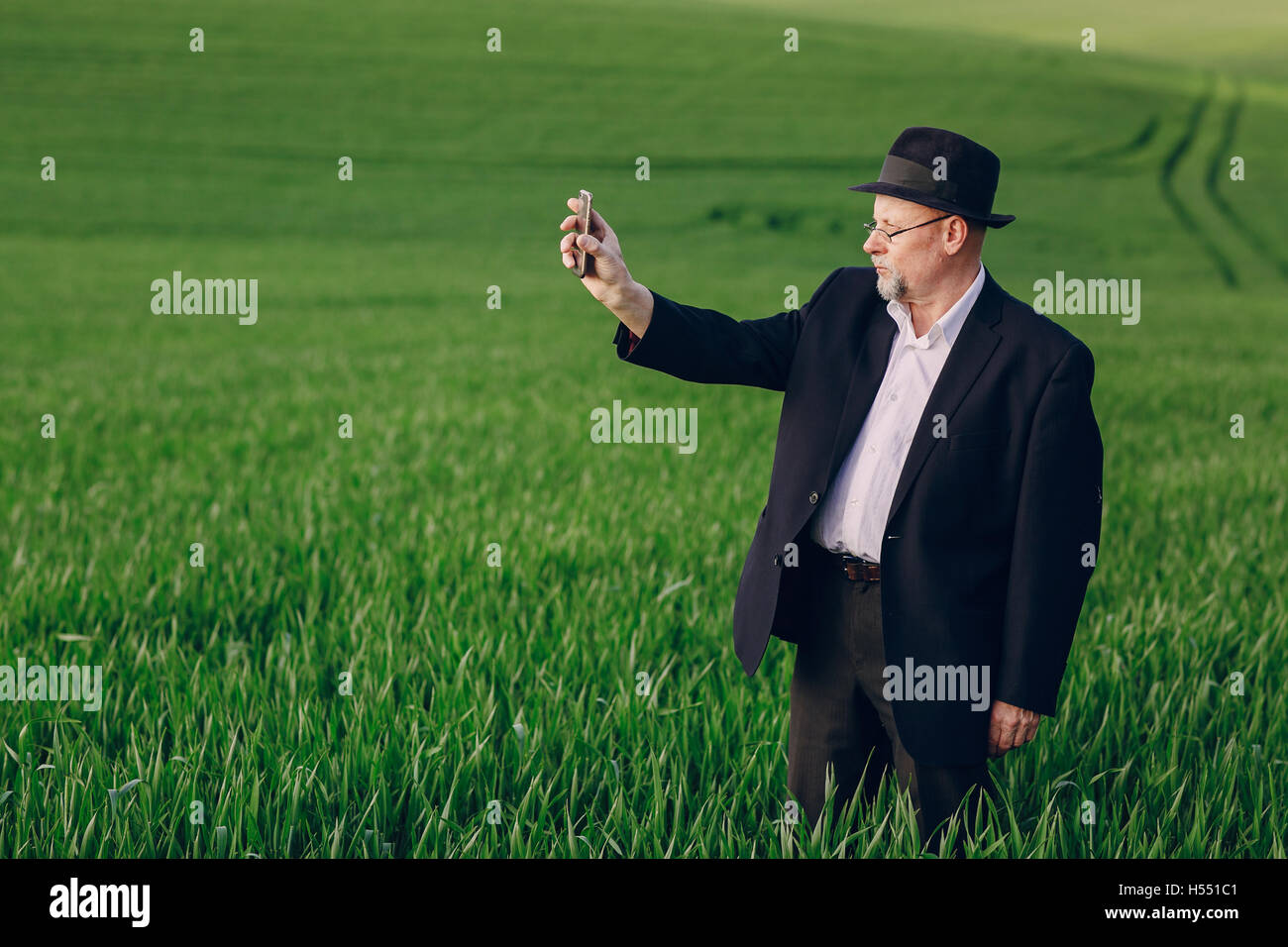 Old man in field stock photo alamy