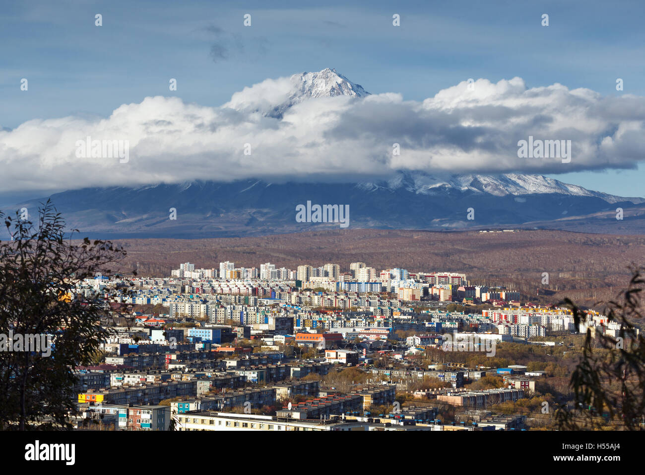 Kamchatka autumn view of city landscape of Petropavlovsk-Kamchatsky City on background beautiful active Koryaksky Volcano. Stock Photo