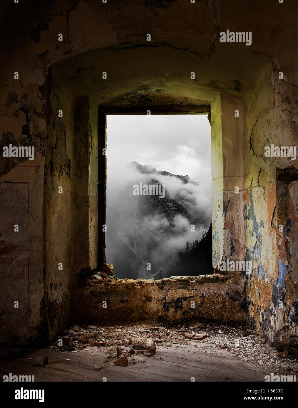 Old window in abandoned place with a mountain view. Stock Photo