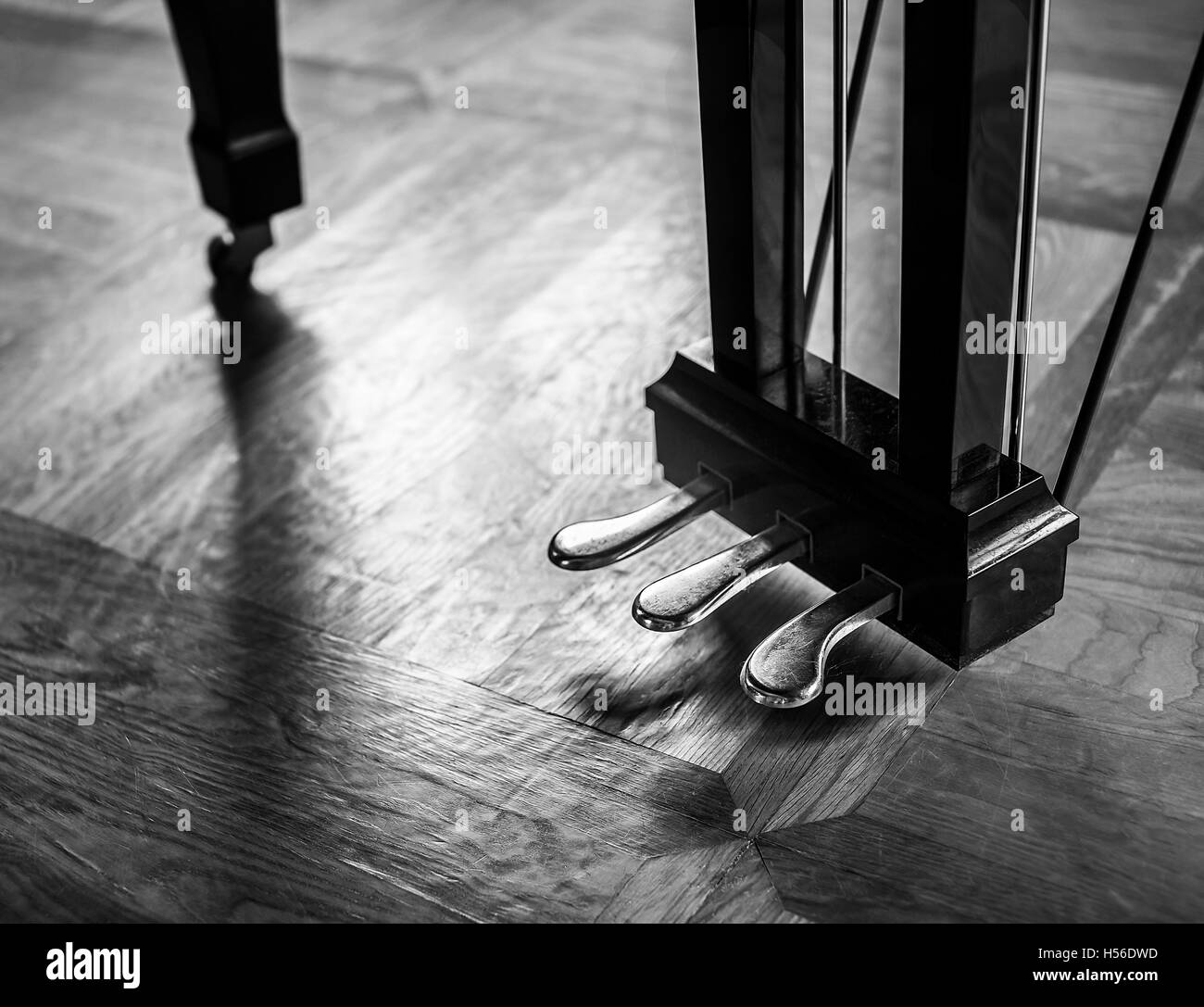 Dramatic piano foot pedals with soft reflection on a floor. Stock Photo