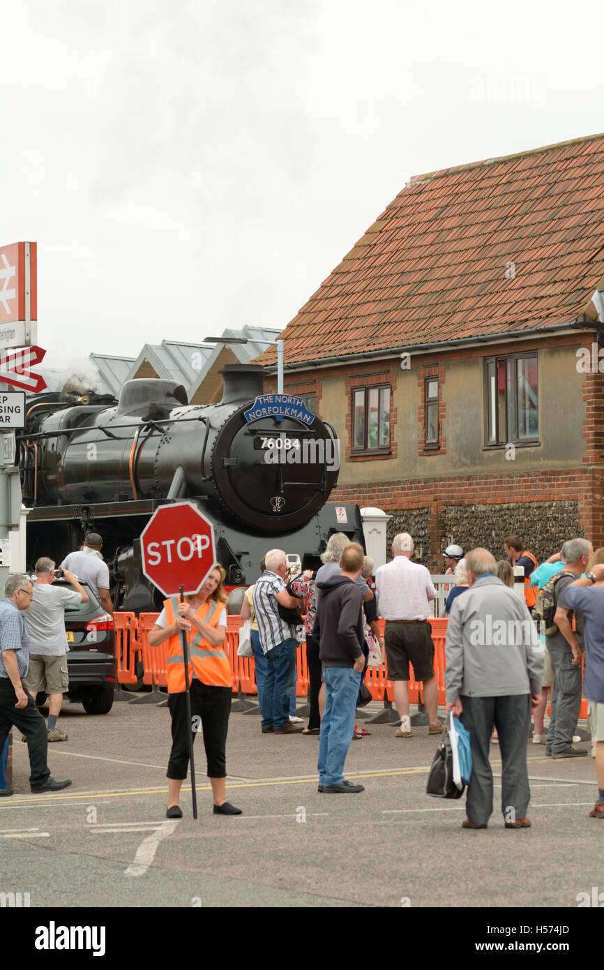 Rail enthusiasts watching The North Norfolkman steam train approaching Sheringham railway station, Norfolk, England Stock Photo