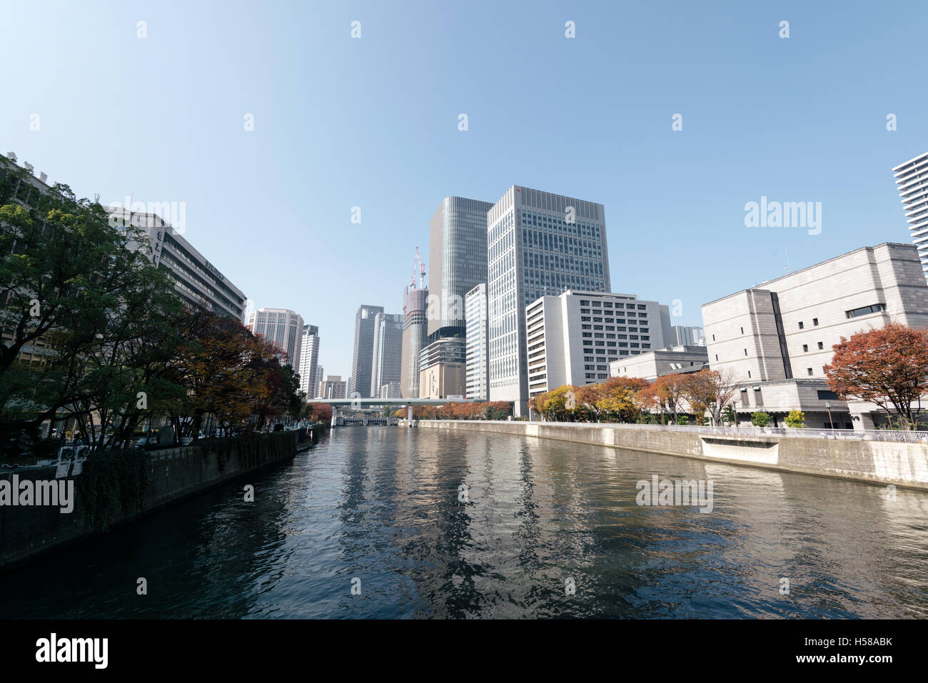 Osaka, Japan - November 30, 2015: Kyū-Yodo River  and  skyscrapers of downtown Osaka, Japan. Osaka is a large port city and comm Stock Photo