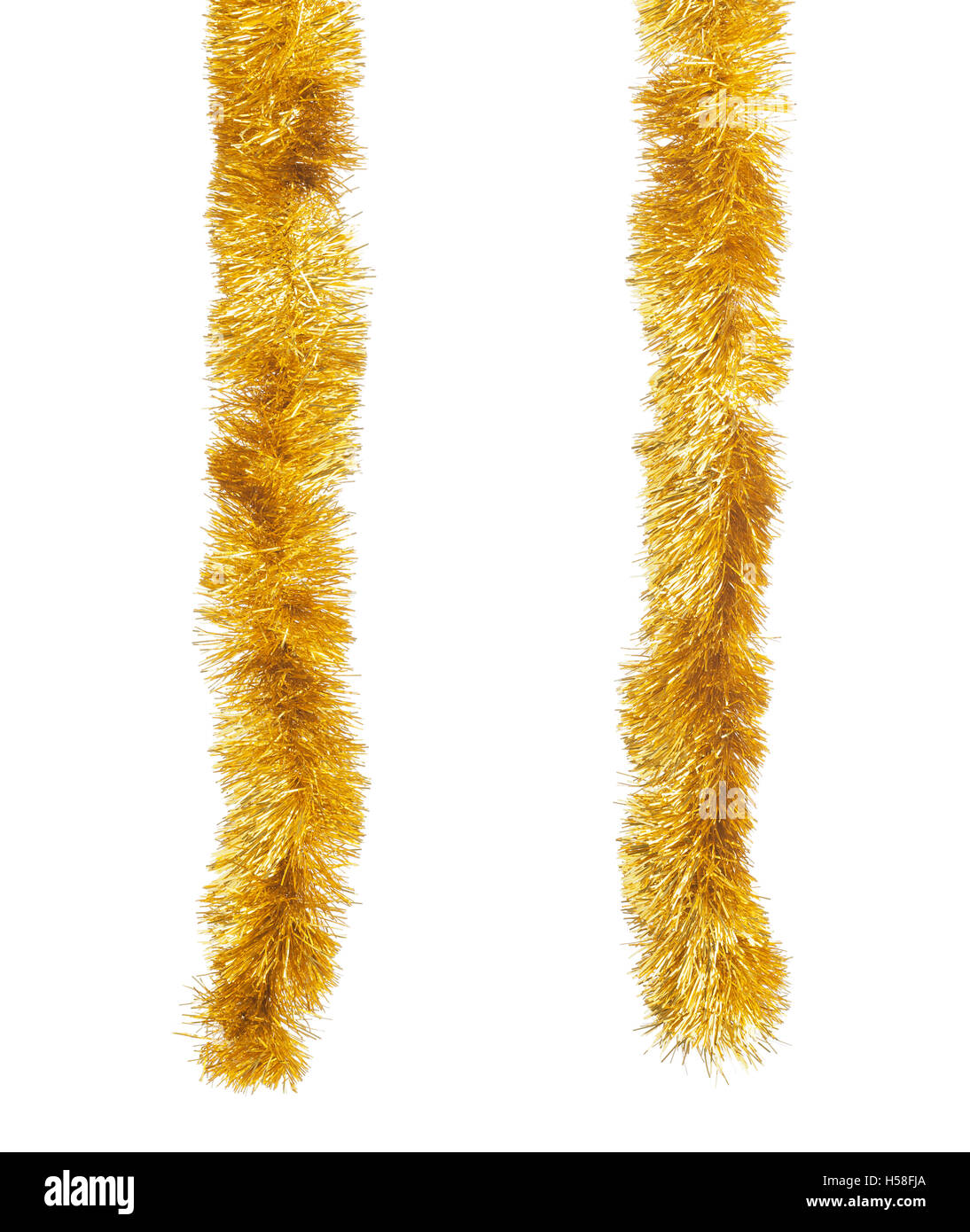 Two golden Christmas tinsels hanging in vertical position. Isolated on white background. Stock Photo
