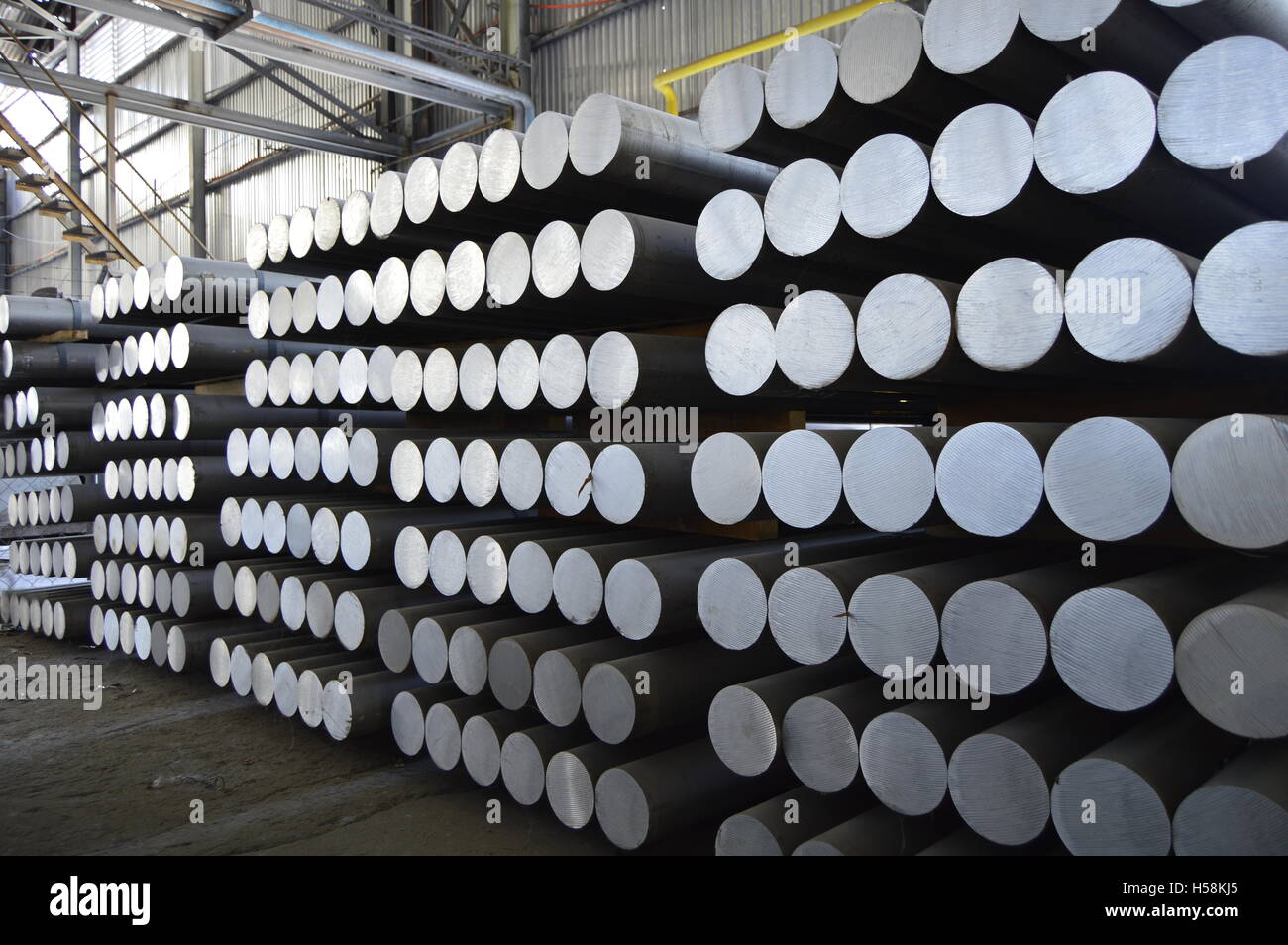 primary aluminum metal cylinders employed in the extrusion process. Stock Photo