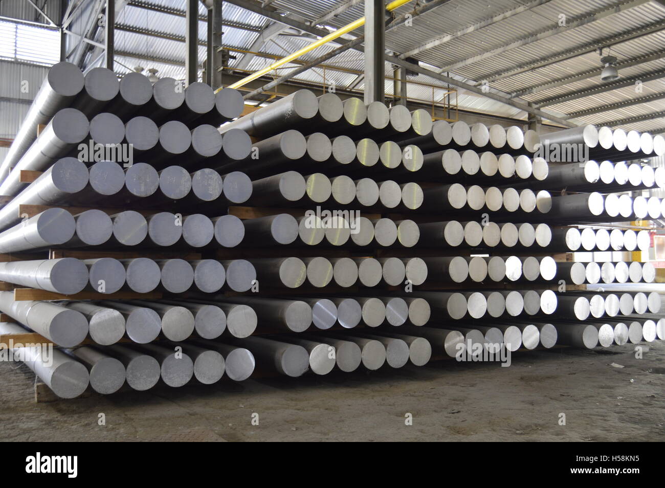 primary aluminum metal cylinders employed in the extrusion process. Stock Photo