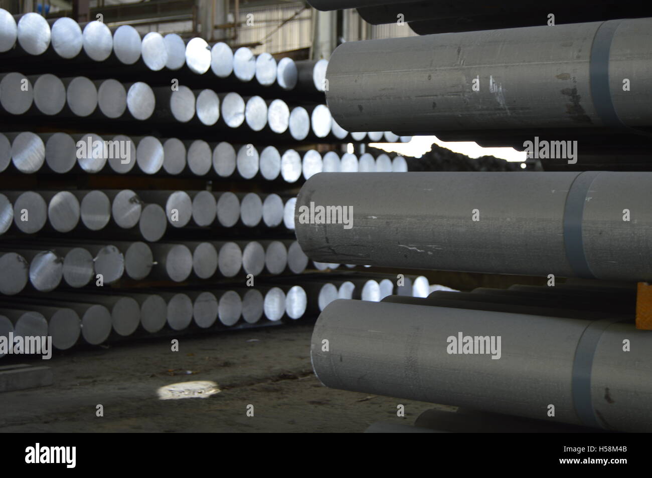 primary aluminum metal cylinders employed in the extrusion process. Stock Photo