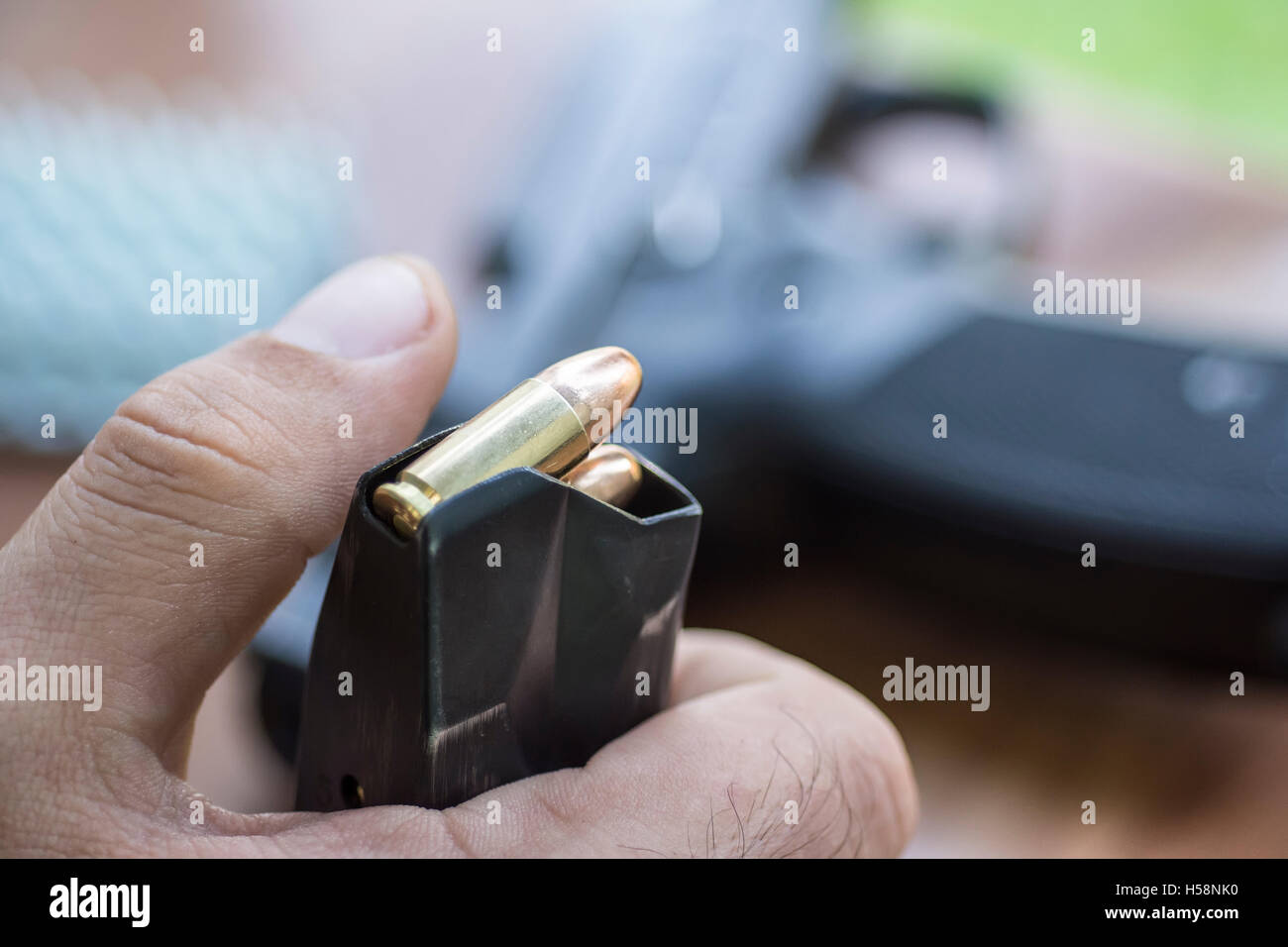 Load 9mm Ammo in the Pistol Clip Close Up. Hands, Bullets, Magazine and Handgun Stock Photo Alamy