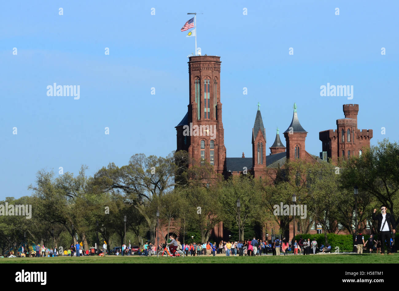 Smithsonian Castle visitor information center,  horizontal, with trees and people in foreground Stock Photo