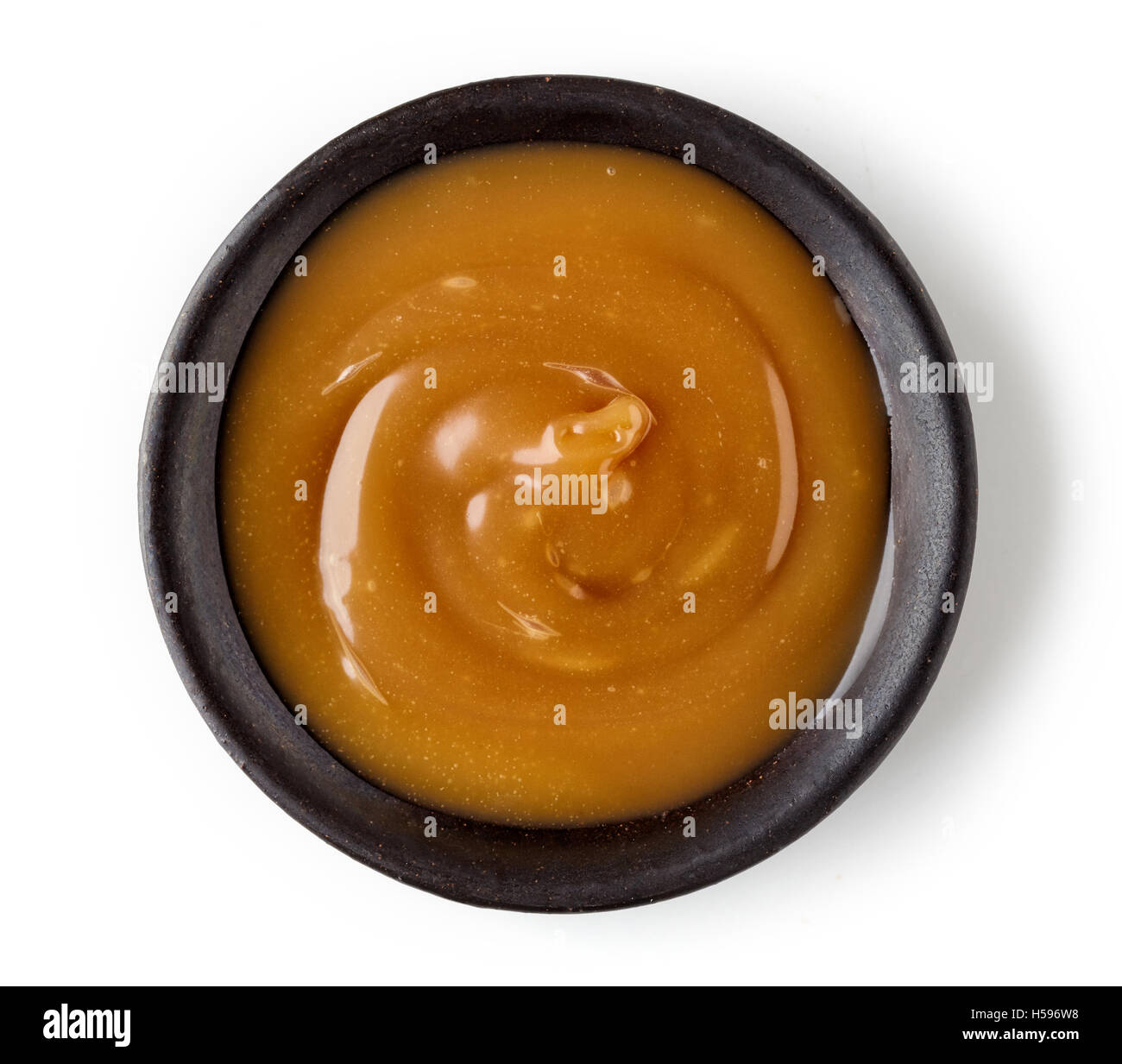 Caramel sauce  in round dish isolated on white background, top view Stock Photo