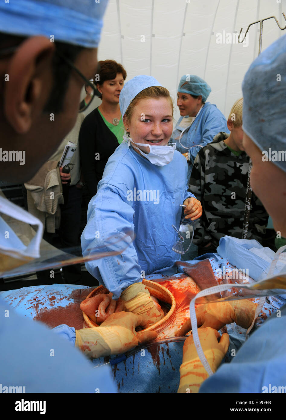 Schoolchildren invited to participate in a simulated surgical operation with a film and tv dummy made by the make-up and prosthe Stock Photo