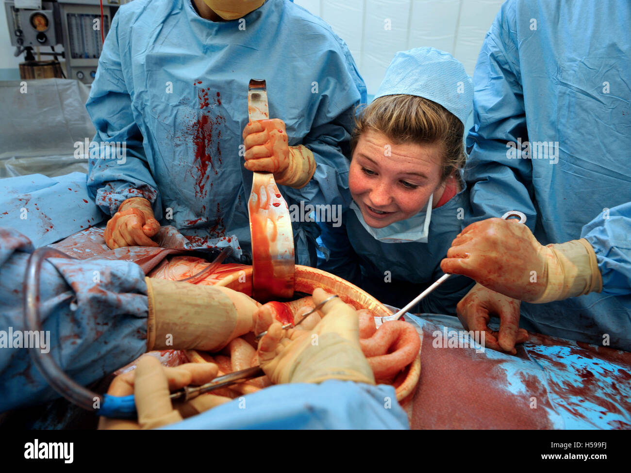Schoolchildren invited to participate in a simulated surgical operation with a film and tv dummy made by the make-up and prosthe Stock Photo