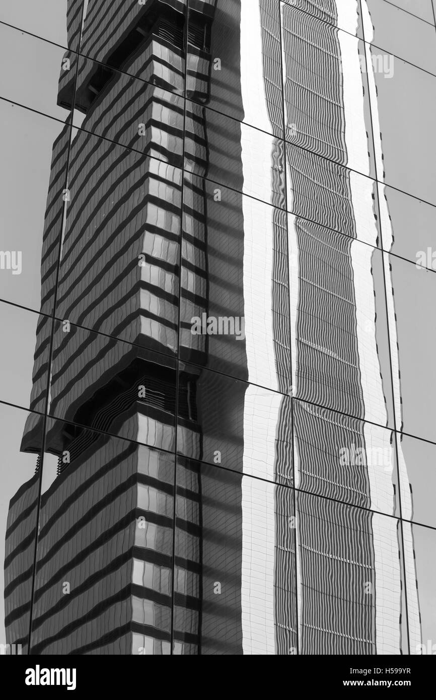 Skyscraper glass reflection in black and white tone. Vertical Stock Photo