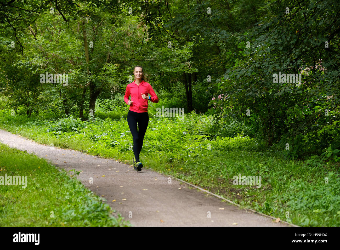 Young woman jogging in the park Stock Photo - Alamy