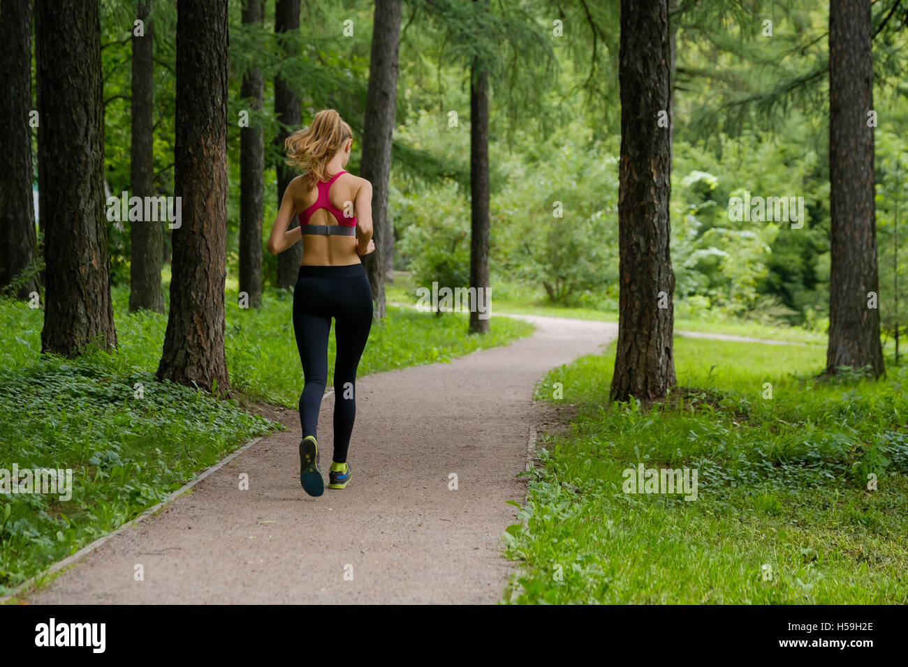 Young woman jogging in the park Stock Photo - Alamy