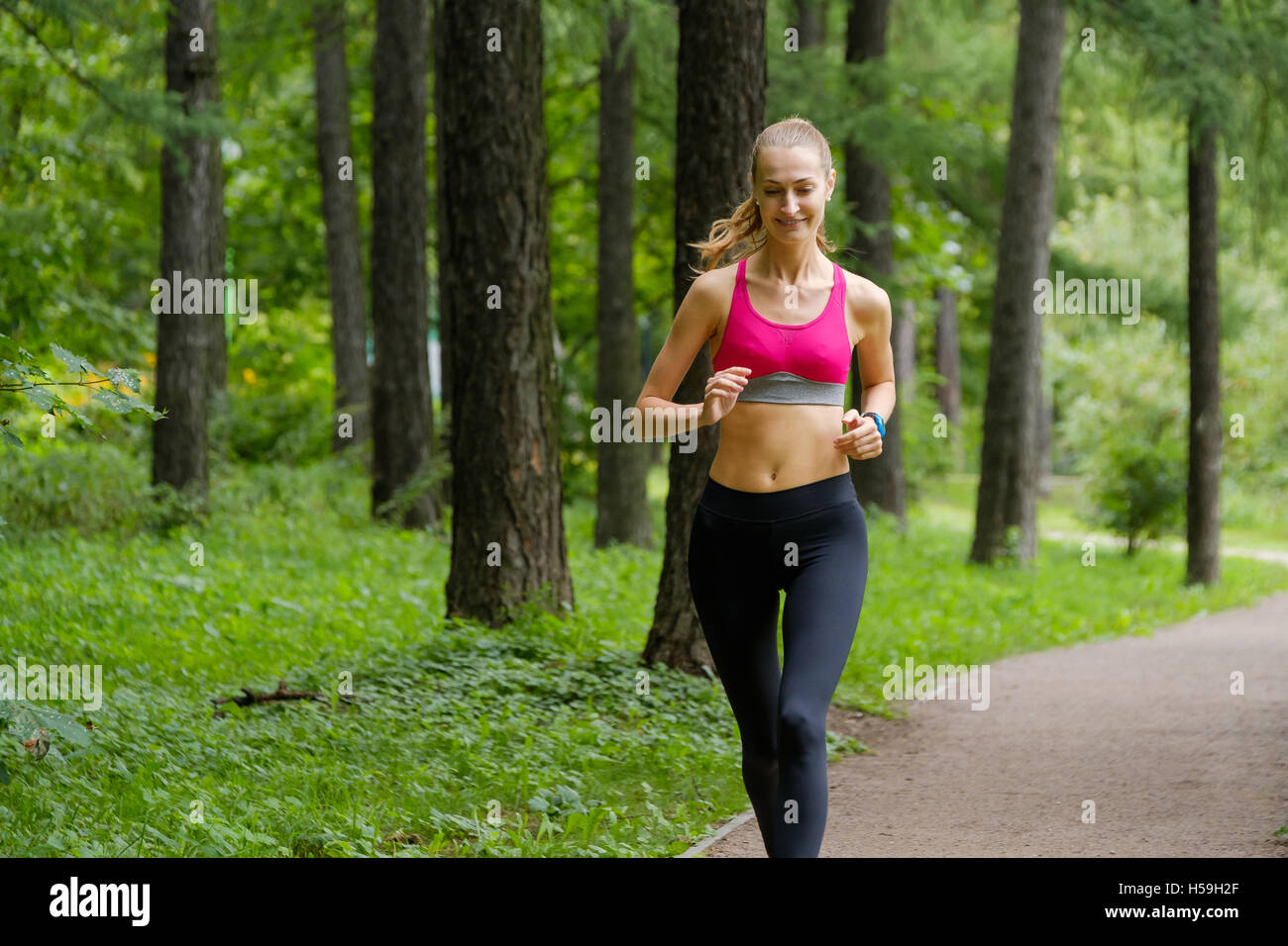 Young woman jogging in the park Stock Photo - Alamy