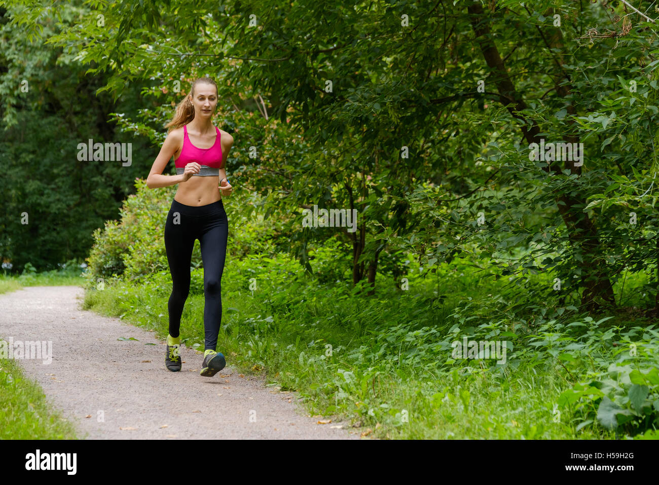 Young woman jogging in the park Stock Photo - Alamy