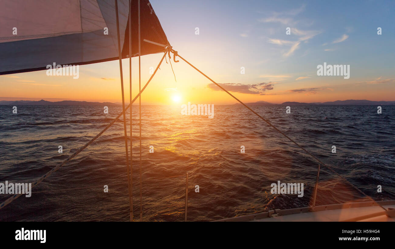 Stunning sunset with sailing yachts in the Sea Stock Photo - Alamy