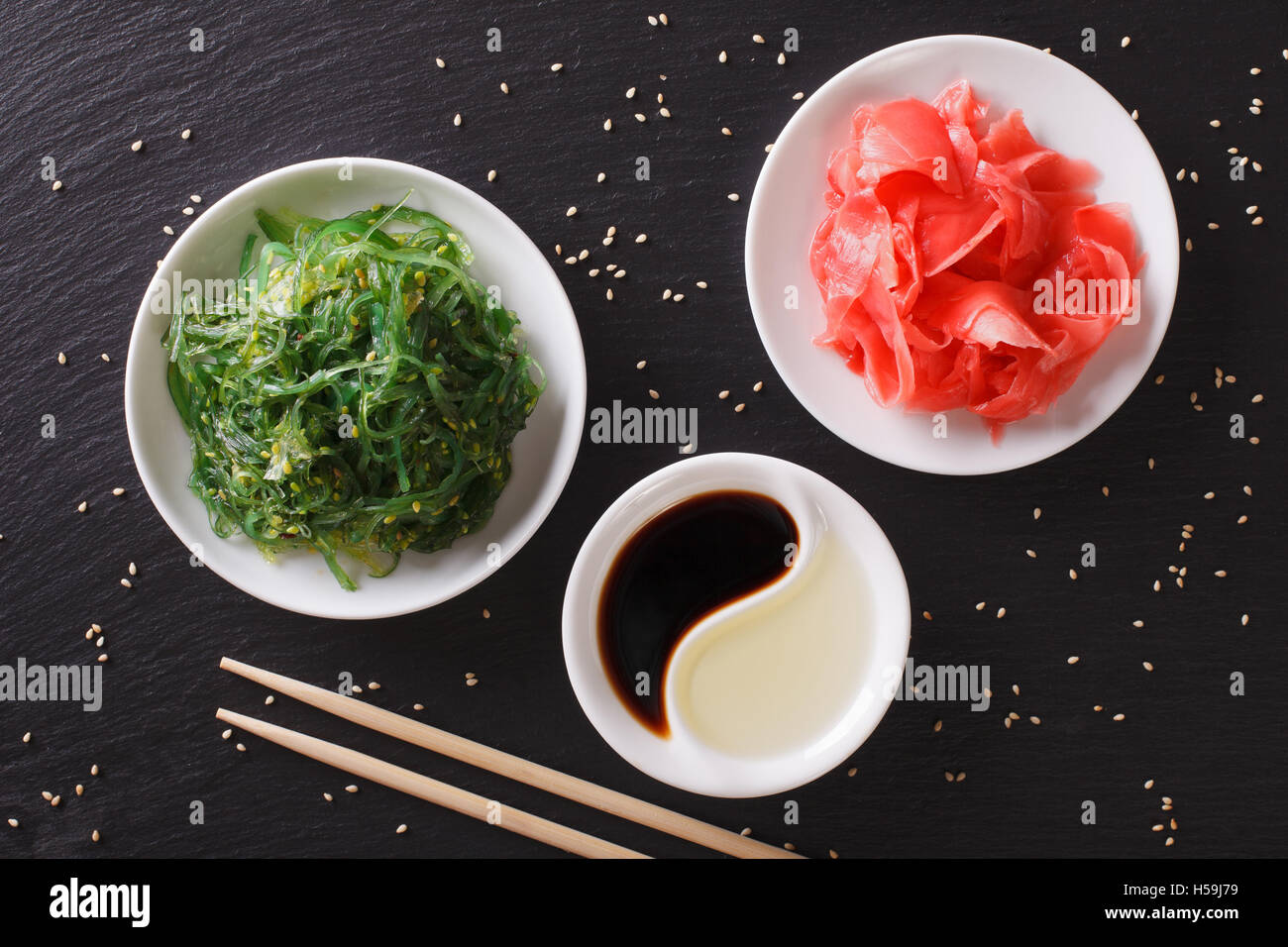Japanese wakame seaweed salad with sesame seeds on a table. Horizontal top view Stock Photo