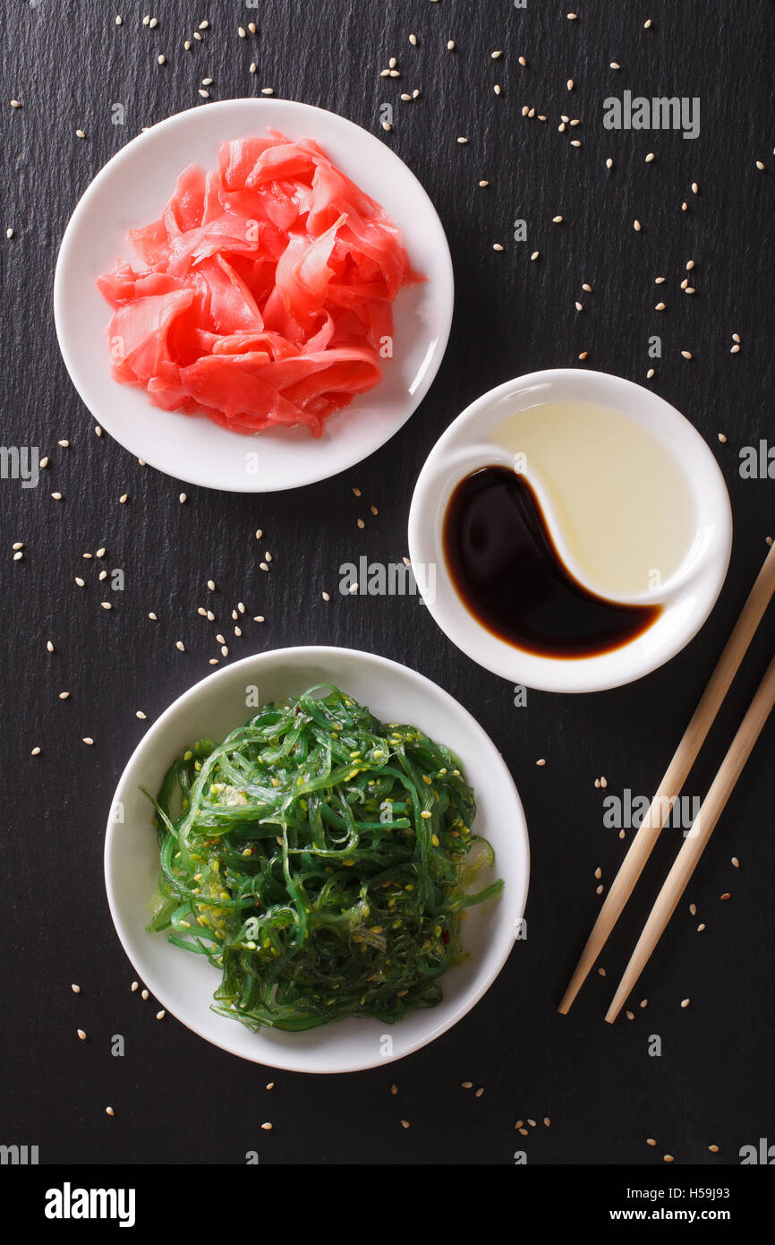 Japanese wakame seaweed salad with sesame seeds on a table. vertical top view Stock Photo