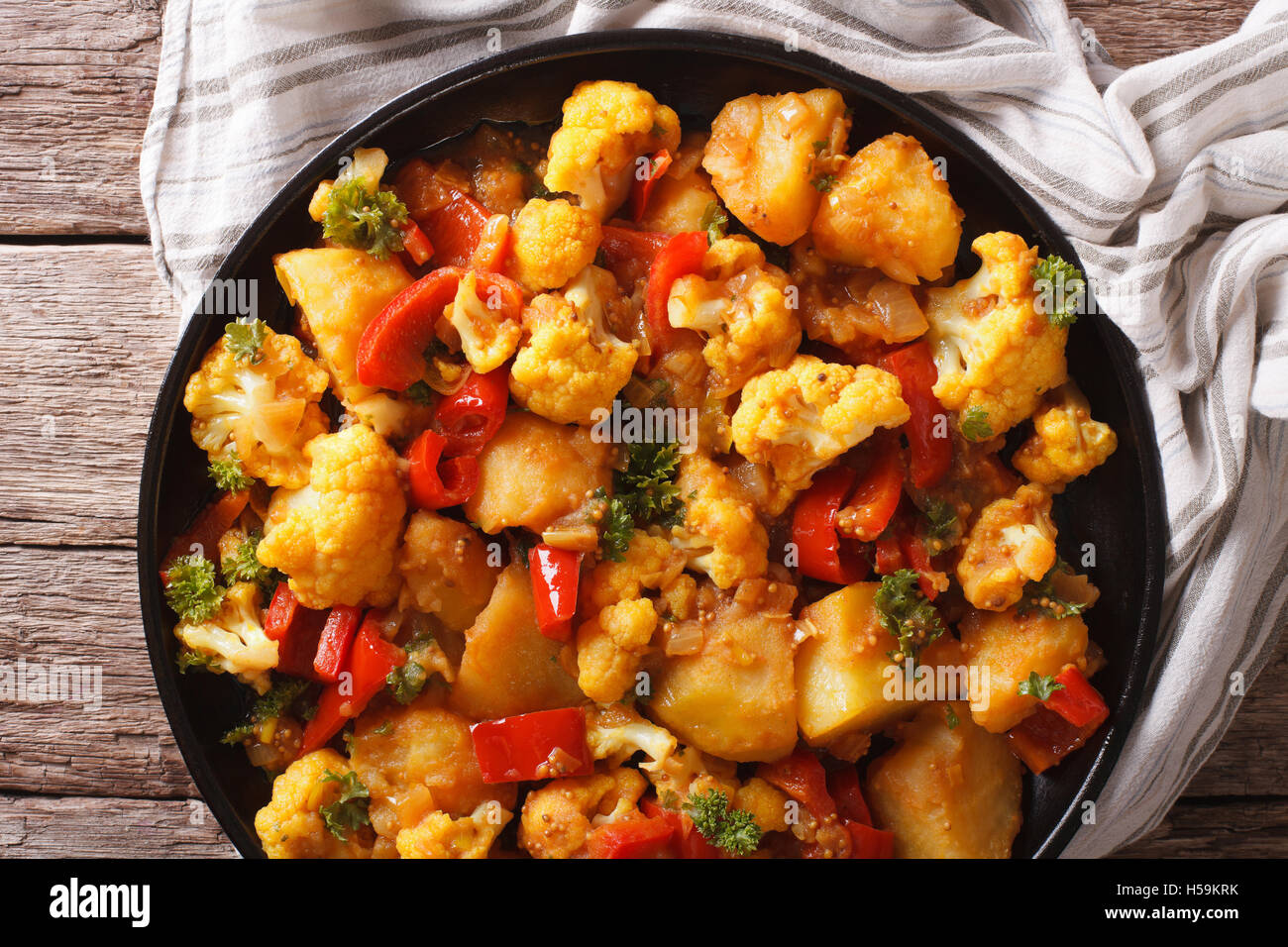 Indian cuisine: Gobi Aloo close-up on a plate on the table. Horizontal top view Stock Photo