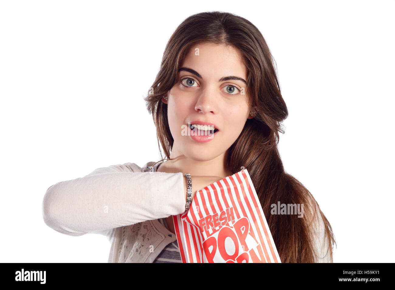 Young beautiful woman eating popcorn. Isolated white background Stock