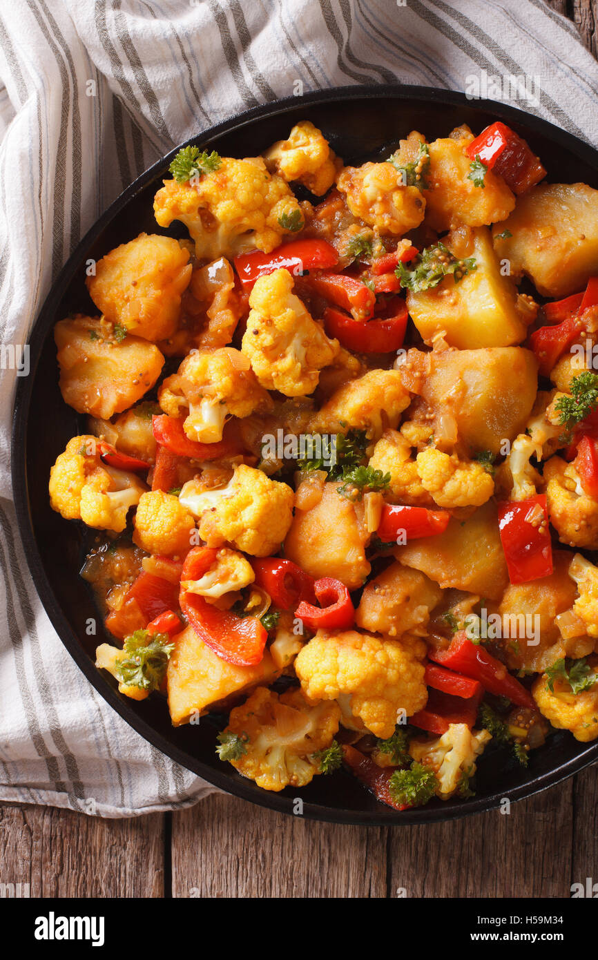Indian cuisine: Gobi Aloo close-up on a plate on the table. vertical top view Stock Photo