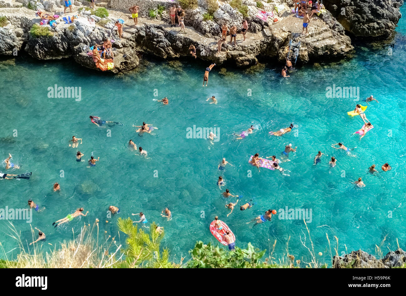 Peoples swim, play, jump and have fun at Acquaviva coastal inlet Stock Photo