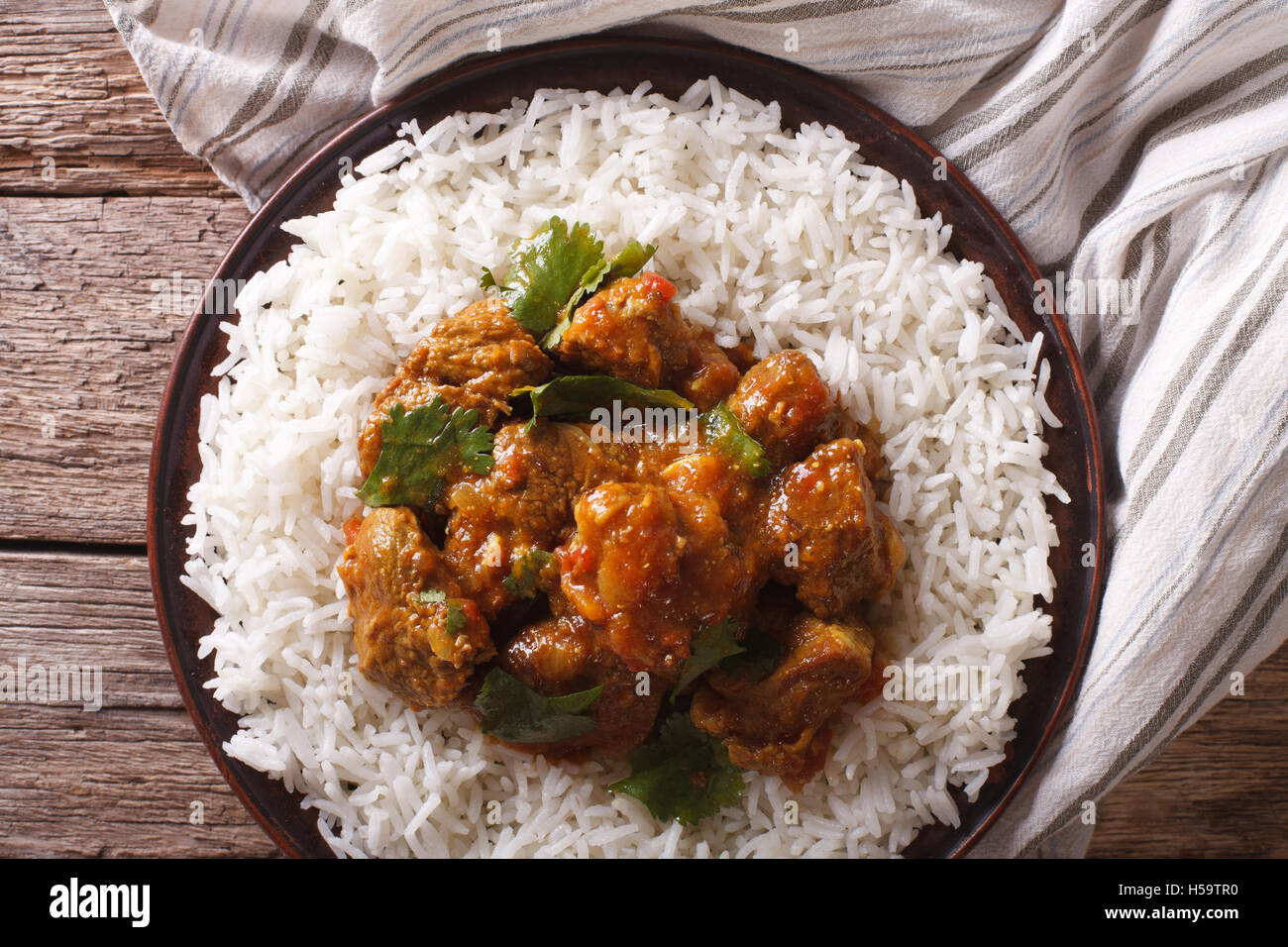 Indian food Madras beef with basmati rice on the table closeup