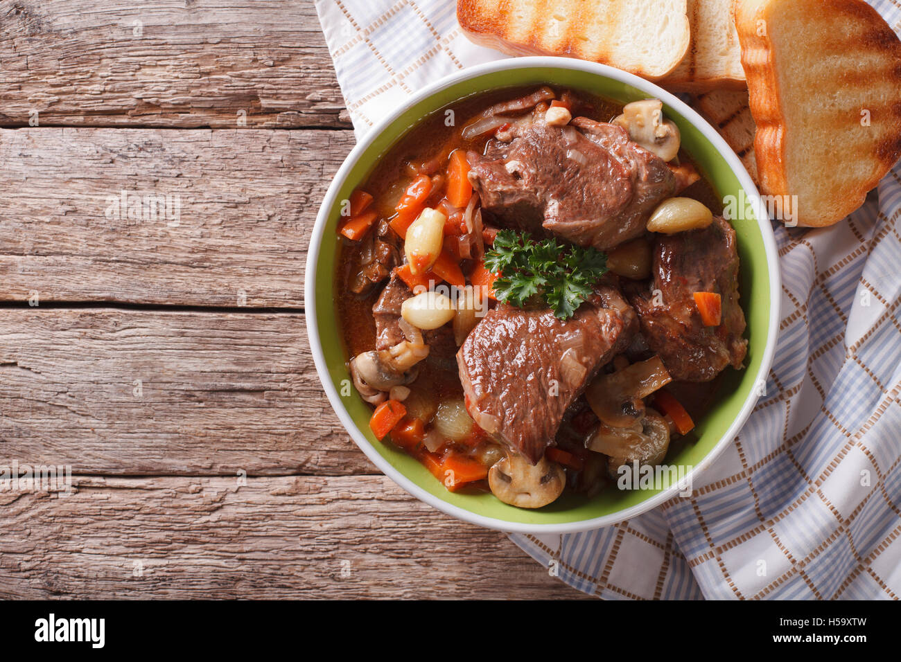 Homemade Beef Bourguignon in a bowl on the table. horizontal view from above Stock Photo
